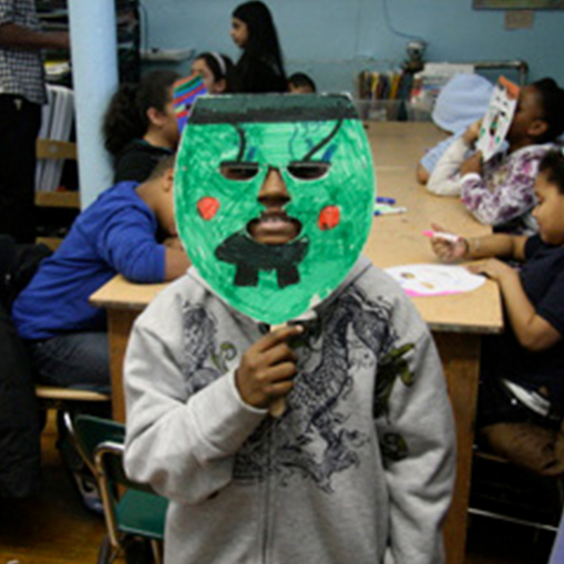 child holding green mask to face