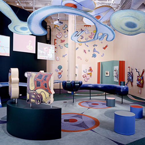 art inside out exhibit space with seating and ceiling art