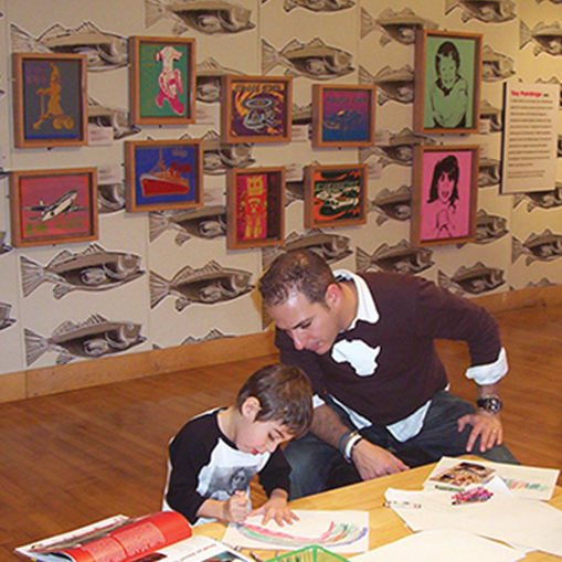 A child and man make art in