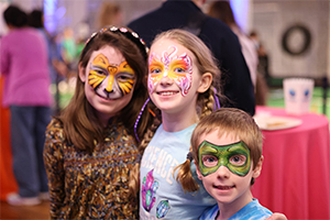 three kids with facepaint smiling