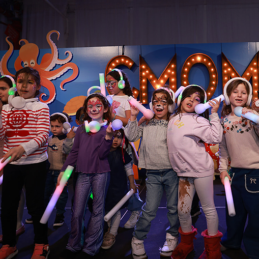 kids on stage with sticks