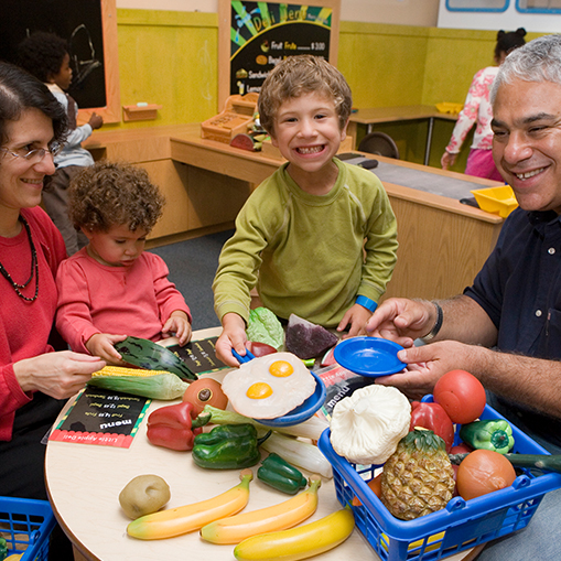 family playing with pretend food