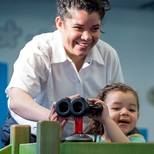woman with child playing with binoculars