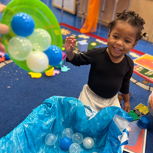 little boy playing with balls