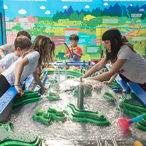 children playing at a water table