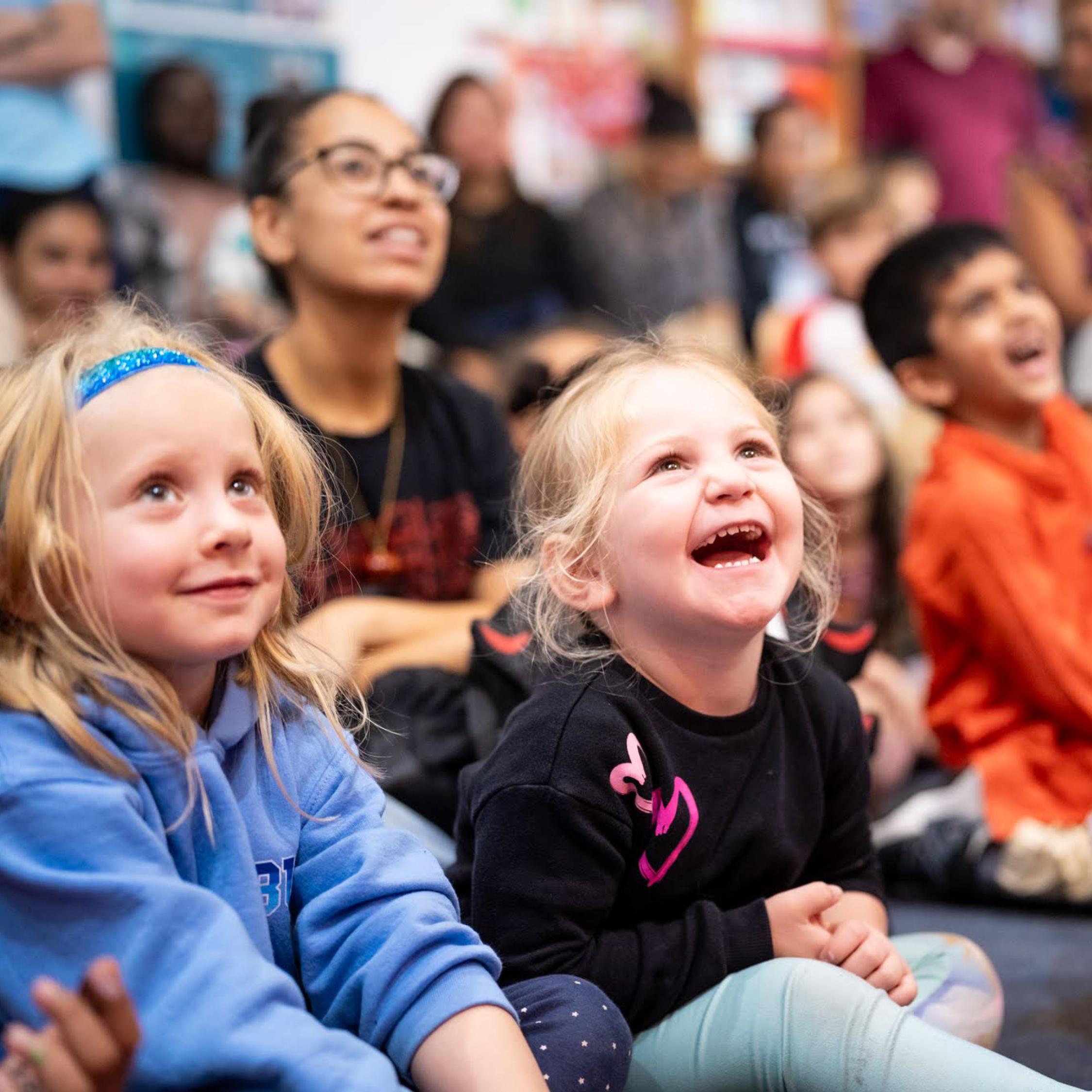 Child laughs happily at a show.