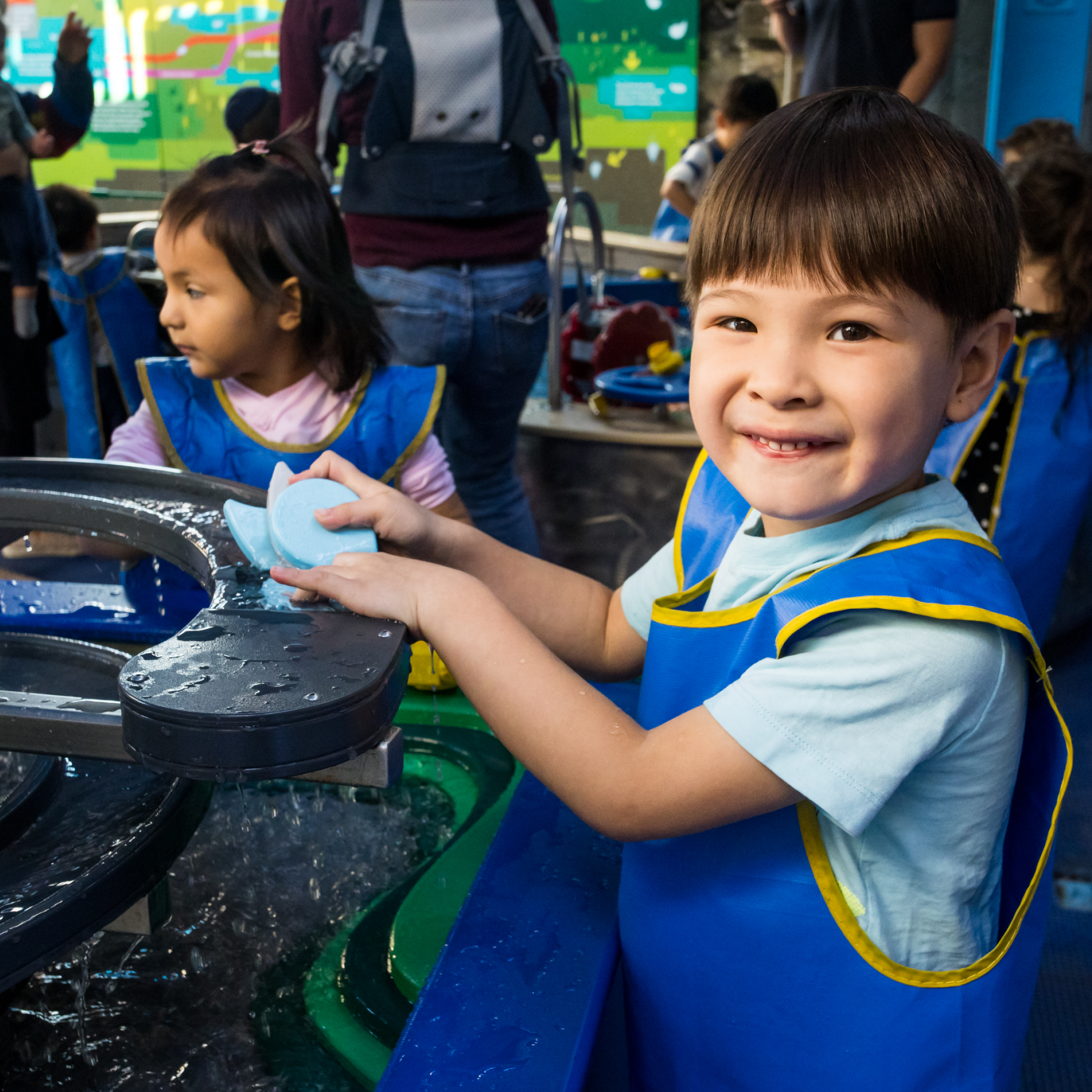 Child plays in the water exhibit H2O